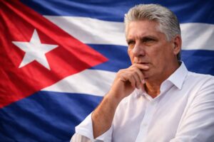 Imagem ilustrativa mostra o presidente de Cuba, Miguel Díaz-Canel, em pose reflexiva diante da bandeira cubana.