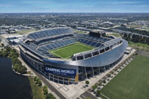 Ilustração fotográfica gerada por IA representando o Camping World Stadium, em Orlando, com vista semiaérea diurna.