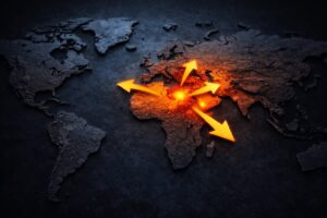 Mapa-múndi em 3D com destaque luminoso na região do Oriente Médio e setas apontando para outras áreas, simbolizando possível expansão do conflito.