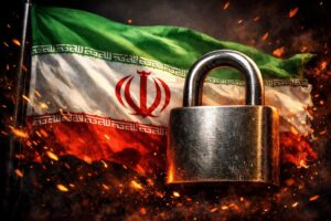 Bandeira do Irã tremulando ao vento com um cadeado metálico em primeiro plano e faíscas ao redor, em montagem ilustrativa gerada por inteligência artificial que simboliza bloqueio ou restrição de bens no país.